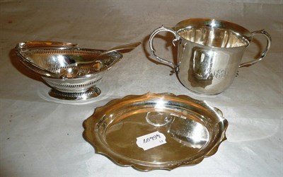 Lot 330 - A silver loving cup, a small oval hinged silver basket, a small oval stand and a sifter spoon (4)