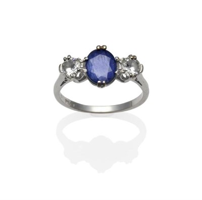 Lot 366 - A Sapphire and Diamond Three Stone Ring, the oval mixed cut sapphire flanked by a round...