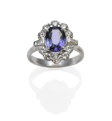 Lot 368 - An 18 Carat White Gold Sapphire and Diamond Cluster Ring, the two tone sapphire of purple and green