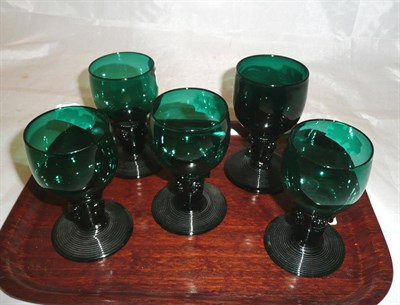 Lot 373 - A group of five late Georgian emerald glass rummers