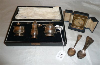 Lot 411 - A silver three piece cruet set, six silver spoons and a cased vintage Zenith alarm clock