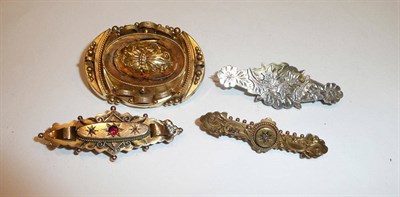 Lot 413 - A Victorian brooch stamped 15k, another stamped 9k, a silver example and a gilt brooch