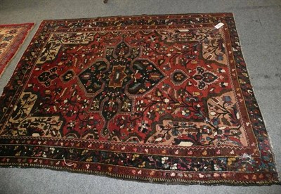 Lot 484 - Bakhtiari Rug West Persia The rose field of angular vines centred by an indigo medallion 183 x...