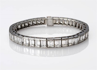 Lot 380 - An Art Deco Diamond Line Bracelet, of graduated baguette cut diamonds in articulated settings,...