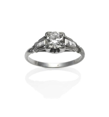 Lot 381 - An Art Deco Diamond Solitaire Ring, the old brilliant cut diamond in a white four claw squared...