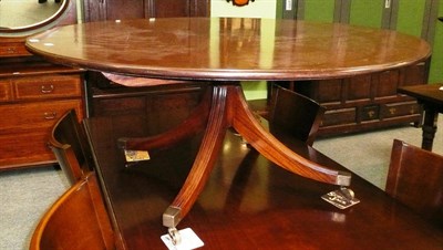 Lot 529 - A reproduction mahogany circular coffee table on four reeded down swept legs with brass toes