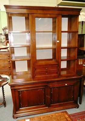 Lot 531 - A reproduction mahogany Le Fablier glazed and open bookcase with cupboards below