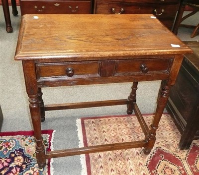 Lot 547 - An oak two drawer hall table on stretcher base