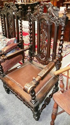 Lot 561 - A 19th century heavily carved oak open armchair