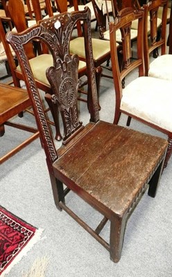 Lot 571 - An 18th century carved oak chair