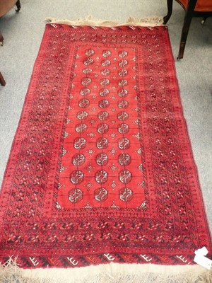 Lot 579 - Afghan rug Afghan Turkestan - The field with three rows of quartered guls, 184 x 115 cm