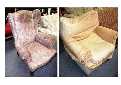 Lot 591 - Floral upholstered wing armchair on square tapering legs and a yellow upholstered easy chair (2)