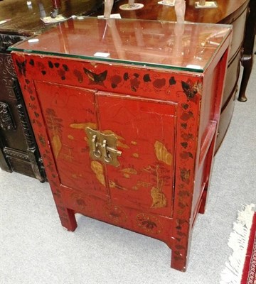 Lot 617 - A Chinese red lacquer cabinet with glass top