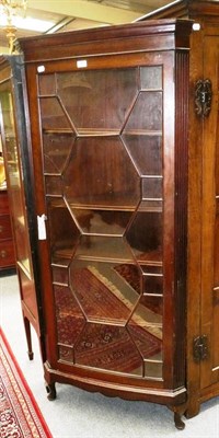 Lot 635 - A glazed mahogany full length floor standing corner cupboard