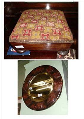 Lot 665 - Small circular framed leather and fruit embossed wall mirror and a rosewood footstool (2)