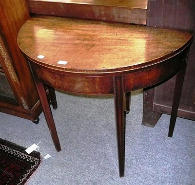 Lot 675 - A Georgian mahogany D-shaped tea table