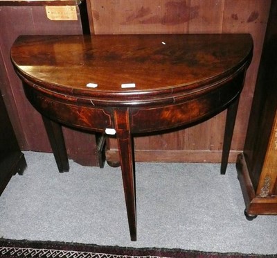 Lot 677 - A Georgian mahogany D-shaped tea table