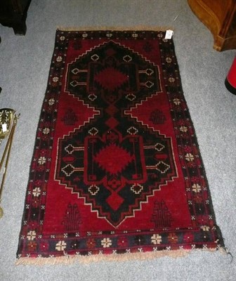 Lot 682 - West Anatolian Village rug - The crimson field with two stepped medallions, 141 x 77 cm