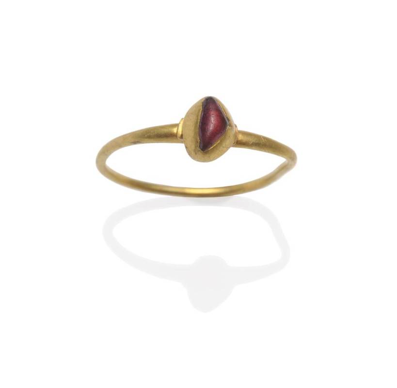 Lot 399 - A Ring, possibly Medieval, a triangular shaped cabochon purpley-red stone collet set in a...