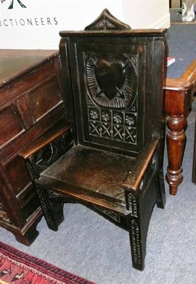 Lot 694 - An 18th century and later carved oak armchair