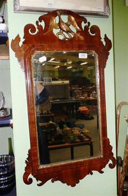 Lot 699 - Mahogany fret cut mirror with a carved bird surmount