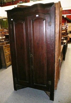 Lot 748 - A large Georgian oak standing corner cabinet