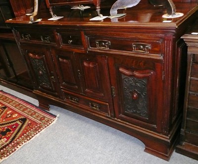 Lot 636A - A late 19th/early 20th century sideboard with carved doors and mirror back