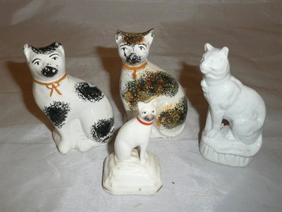 Lot 2 - An English porcelain seated cat figure circa 1840, two Staffordshire pottery sponged cats and a...