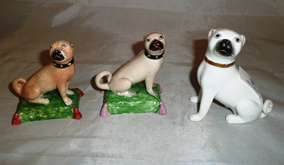 Lot 9 - An English Pearlware pottery Pug on cushion figure circa 1820, another similar; one other Pug...