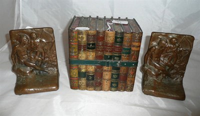 Lot 18 - A Huntley & Palmers biscuit (Reading & London) tin as eight decorative books tied by a belt; a pair