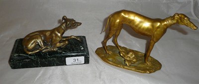 Lot 31 - A gilt metal figure of a recumbent Greyhound, on a verde antico marble rectangular plinth 16cm...