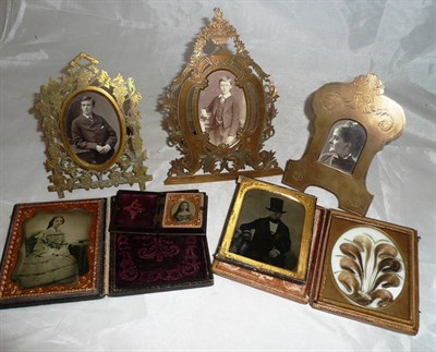 Lot 37 - Three late Victorian gilt brass, engraved/pierced decorative easel backed photograph frames;...