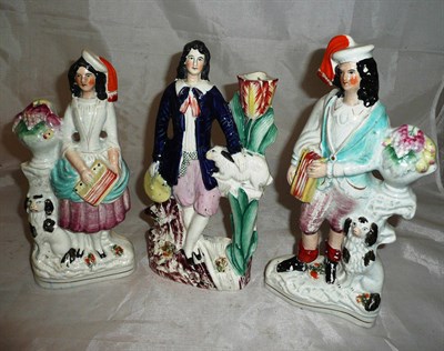 Lot 41 - A pair of Staffordshire pottery figures of Accordionists with Spaniels and another of a young...