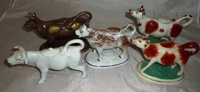 Lot 43 - Five pottery cow creamers
