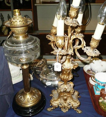 Lot 49 - Gilt metal five branch electrified candelabra and a late 19th century oil lamp with clear glass...