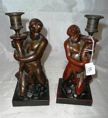 Lot 55 - A rare pair of simulated bronze Triton candlesticks by Cauldwell & Son