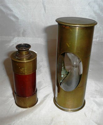 Lot 74 - A rare Trinity House brass cased sandglass and a brass and mahogany four draw telescope (2)