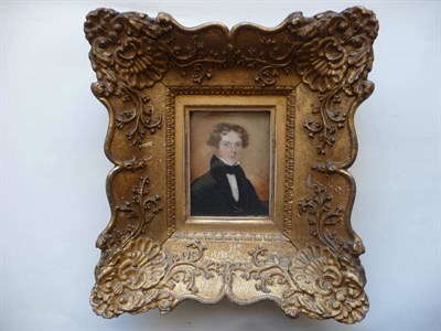 Lot 116 - English School (19th century): Portrait Miniature of a Young Man, half length, wearing black...