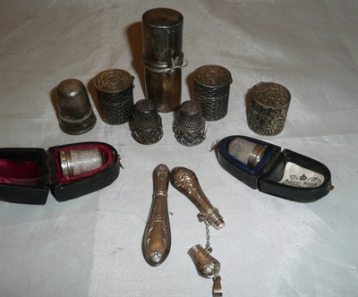 Lot 154 - Silver bodkin in a cylindrical silver case, two small basket style thimble holders, another similar