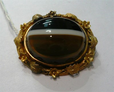 Lot 163 - A sardonyx and locket swivel brooch within a vine and floral decorated frame (a.f.)