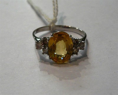 Lot 164 - A 14ct white gold yellow sapphire and diamond ring