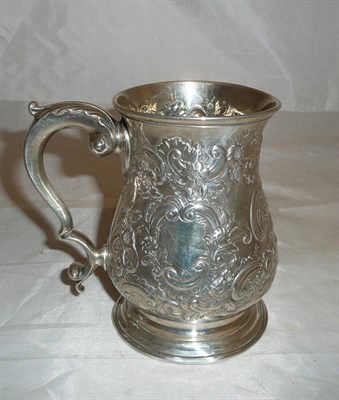 Lot 189 - A George II mug, London 1759, with late foliate chasing, 13cm high