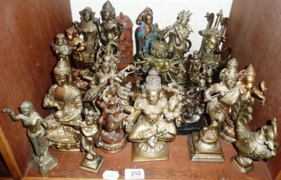 Lot 212 - A shelf of predominantly Indian bronze and gilt metal deities