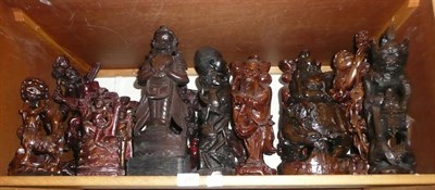 Lot 217 - A shelf of carved wooden figures including examples from Japan, Indonesia and Africa