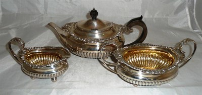 Lot 264 - A silver three piece tea service with cast decoration