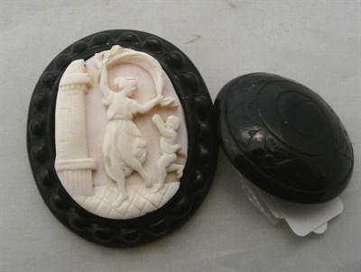 Lot 275 - A jet framed cameo brooch and a jet disc brooch