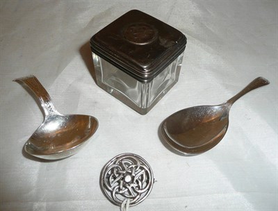 Lot 277 - Two silver caddy spoons, a silver Celtic brooch and a silver-topped jar