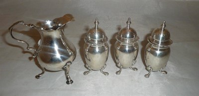 Lot 304 - A silver cream jug and three piece cruet set