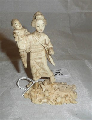 Lot 329 - Ivory group of a lady and child