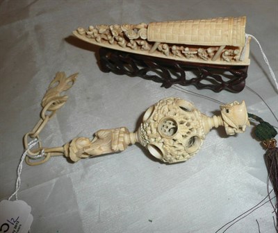 Lot 335 - A carved ivory model of a ship populated with figures on a carved wooden stand and a Chinese carved